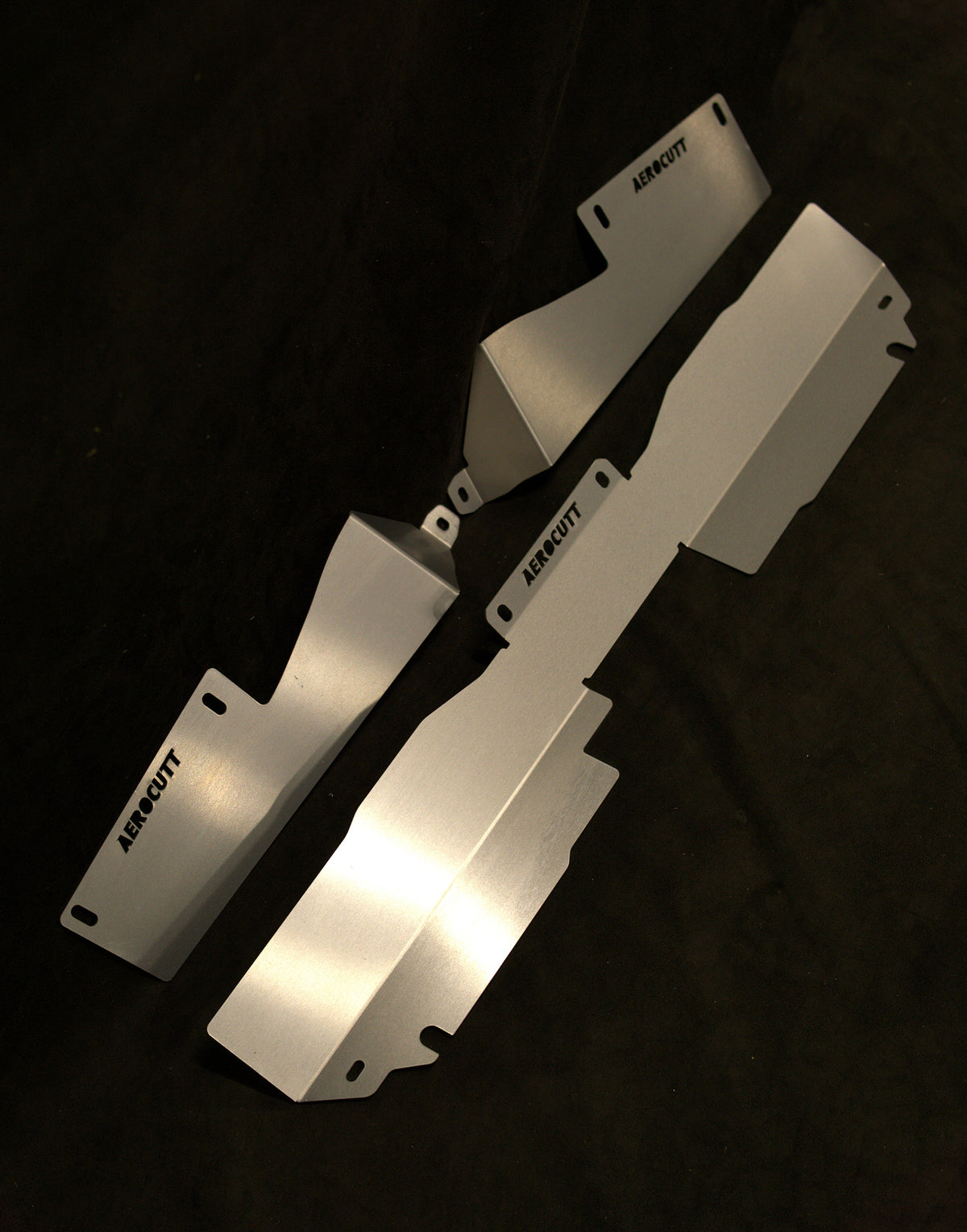 A set of silver aerodynamic cooling panels designed for a Nissan R31 Skyline Series 3 made by Aerocutt