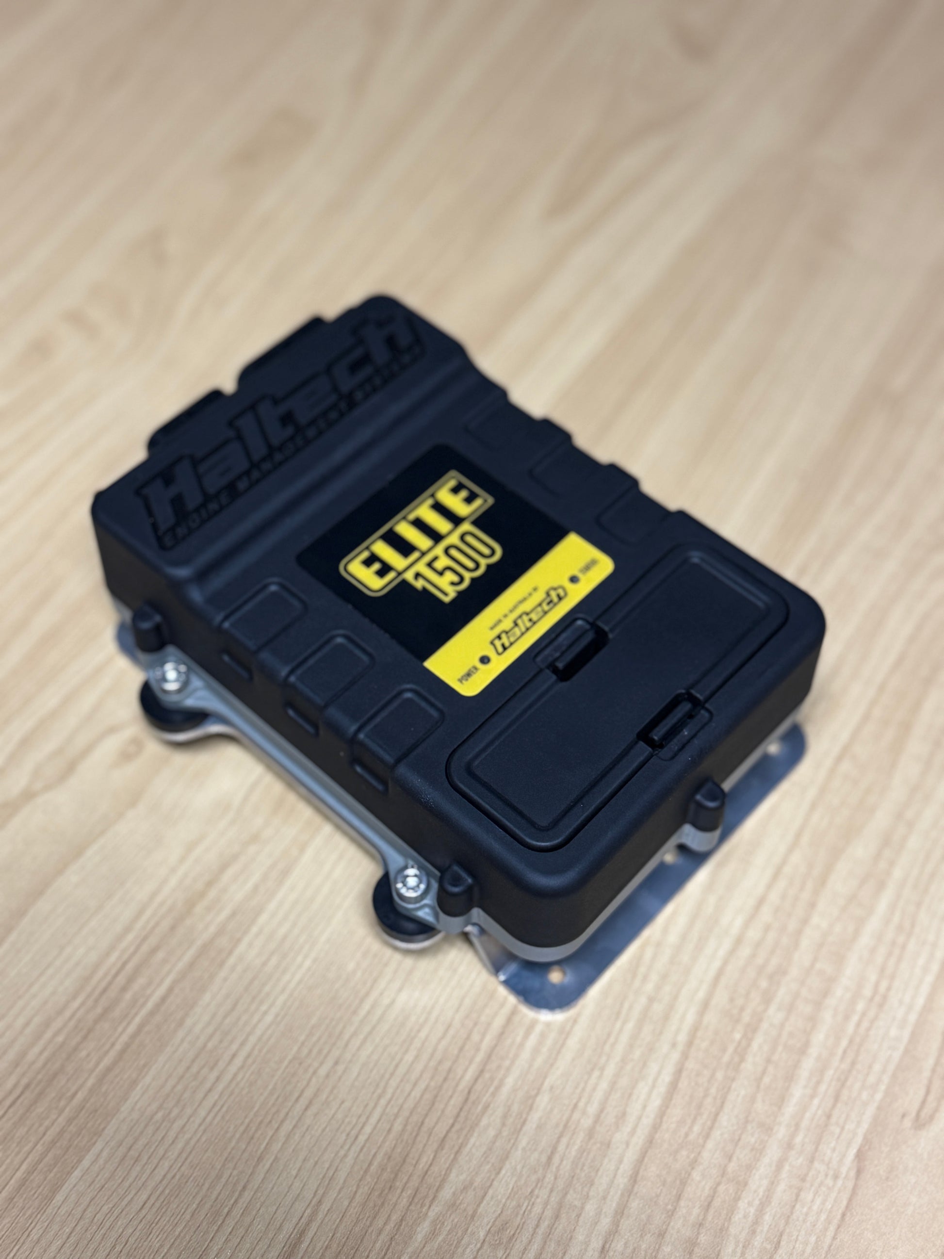 black & yellow haltech elite 1500 safely bolted to bracket 