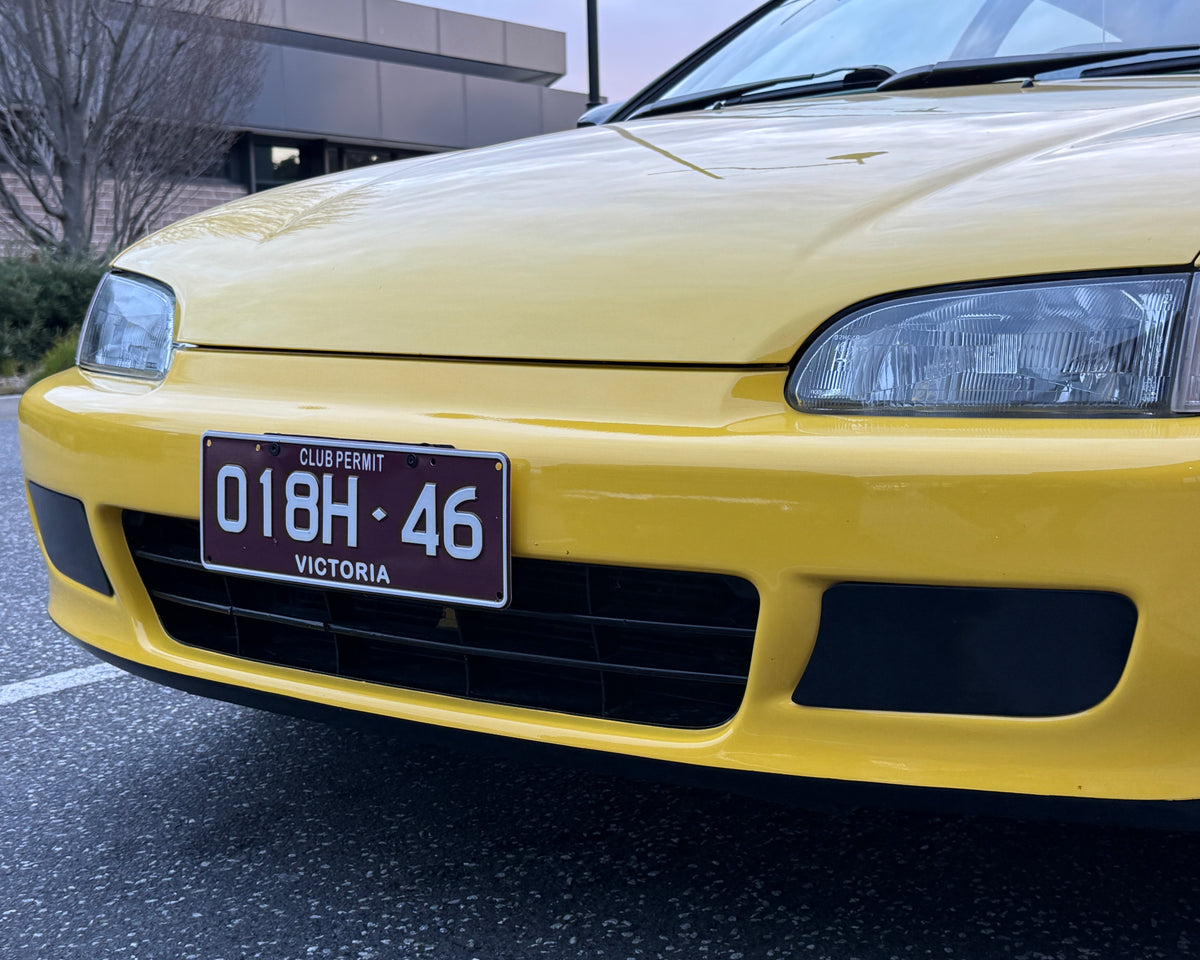 Yellow Honda Civic EG3 front with Aerocutt plastic fog light delete blank plates installed
