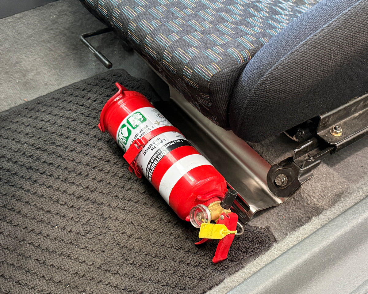 Honda Civic EG 5th Generation passenger side interior with an Aerocutt stainless steel fire extinguisher mount with a 1kg fire extinguisher securely mounted