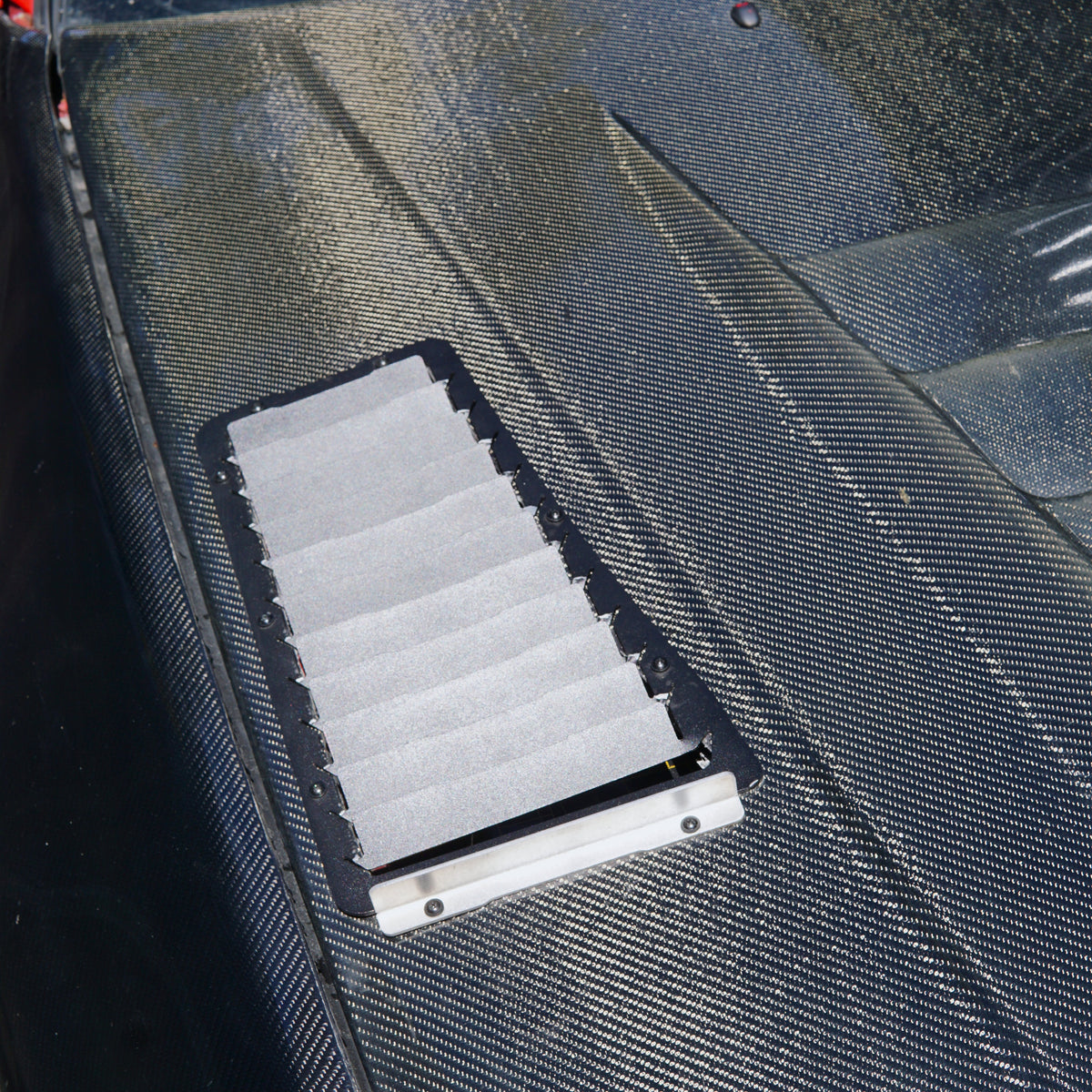 Carbon fibre bonnet on nissan race car with aerocutt bonnet vents installed