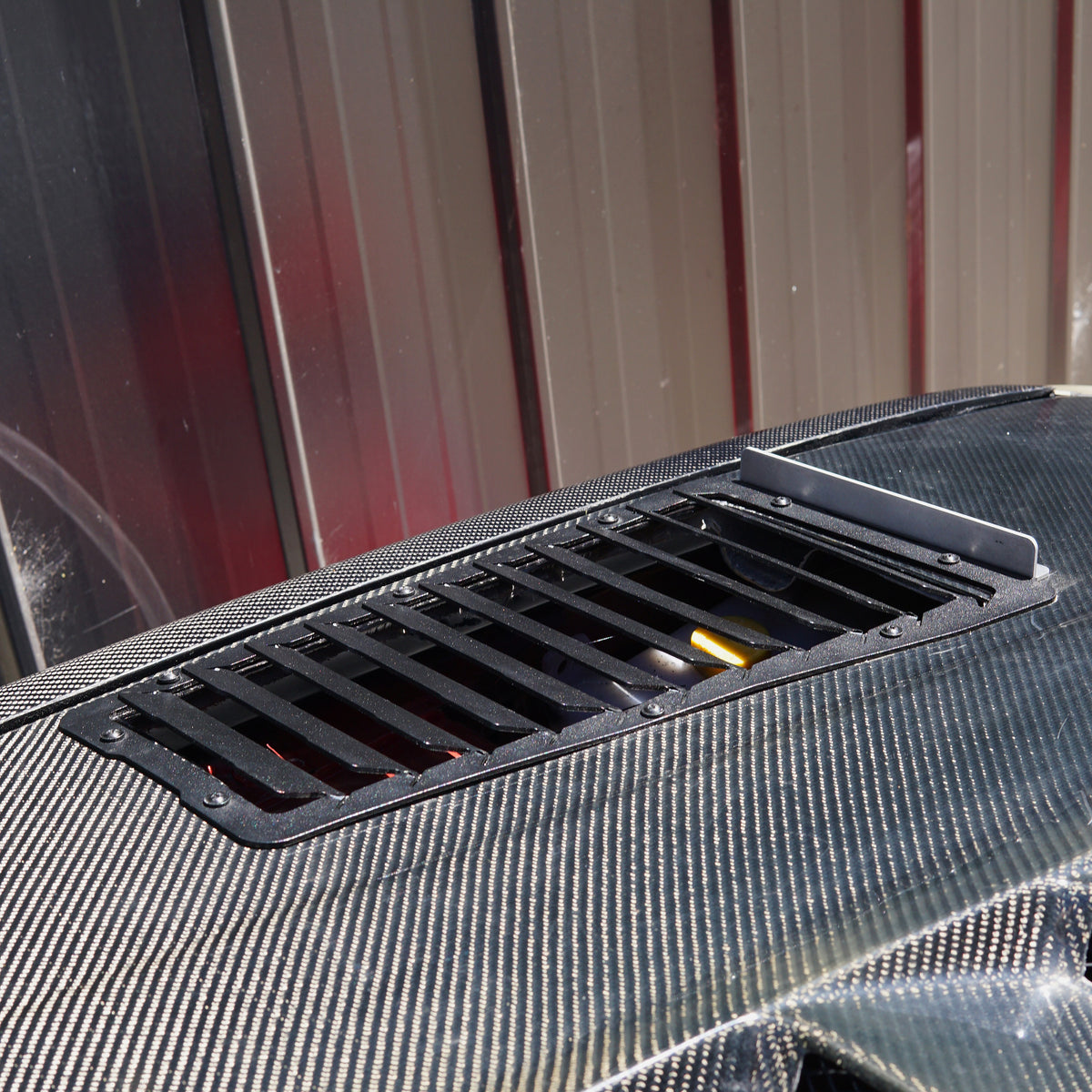Carbon fibre bonnet on nissan race car with aerocutt bonnet vents installed for cooling benefits