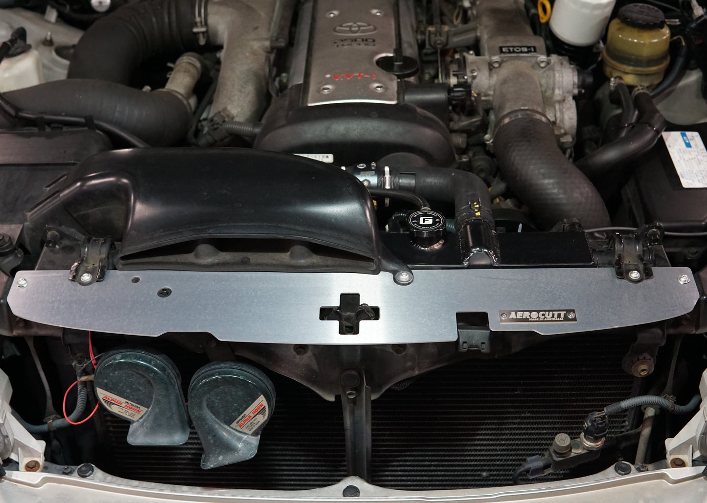 Toyota Crown JZS171 engine bay with shiny Aerocutt Aluminium Radiator Cooling Panel installed