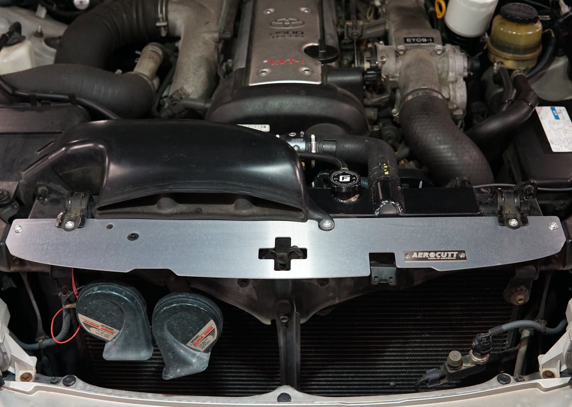 Toyota Crown JZS171 engine bay with shiny Aerocutt Aluminium Radiator Cooling Panel installed