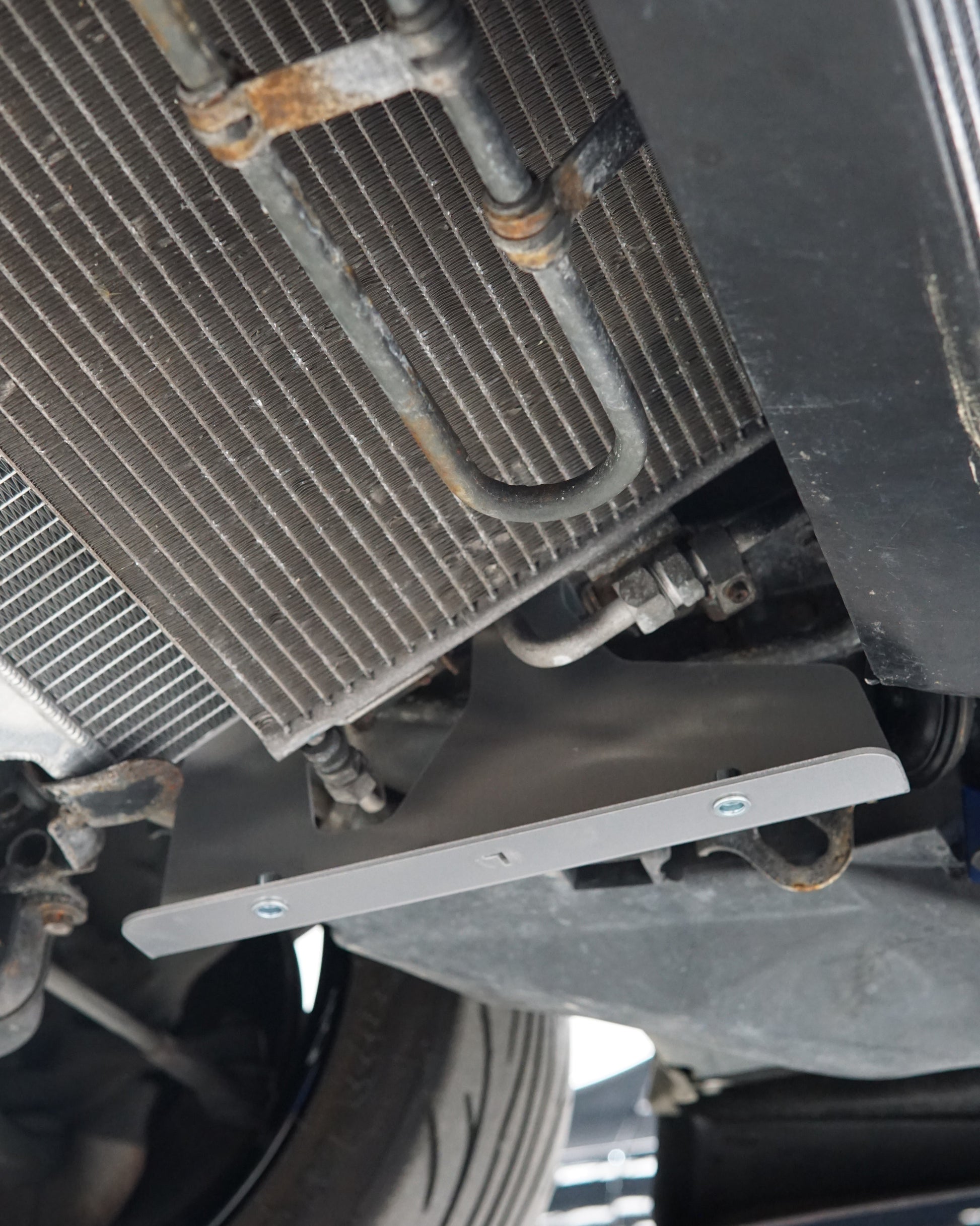Mazda FD RX-7 Underbody with an Aerocutt aluminium front undertray support brace installed.