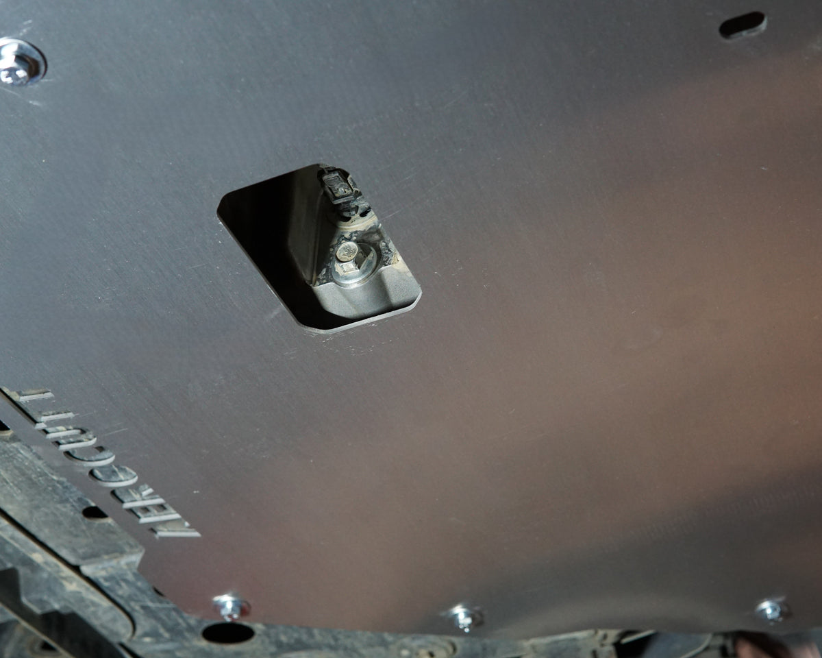 Holden VE Commodore on a lift showing the underside with an aerocutt heavy duty aluminium undertray engine protection plate