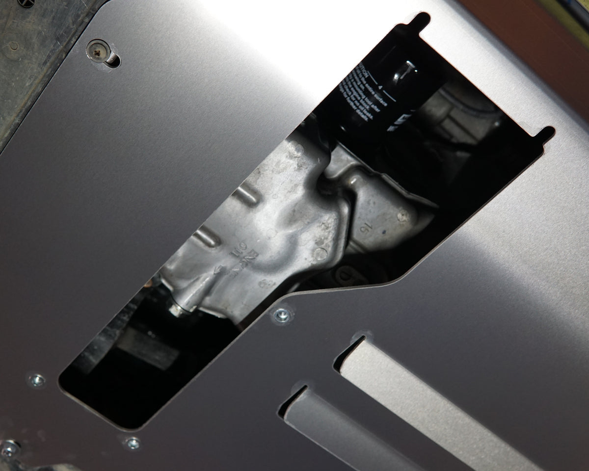 A yellow Honda GK Jazz Undercarriage With an Aerocutt bash plate undertray fitted showing the removable oil service plate for convenience