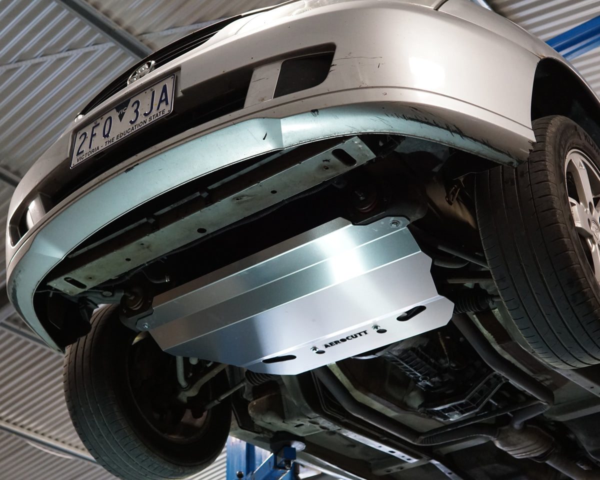 Holden Commodore VT front undercarriage with an Aerocutt steel heavy duty skid plate installed on the underside of the car