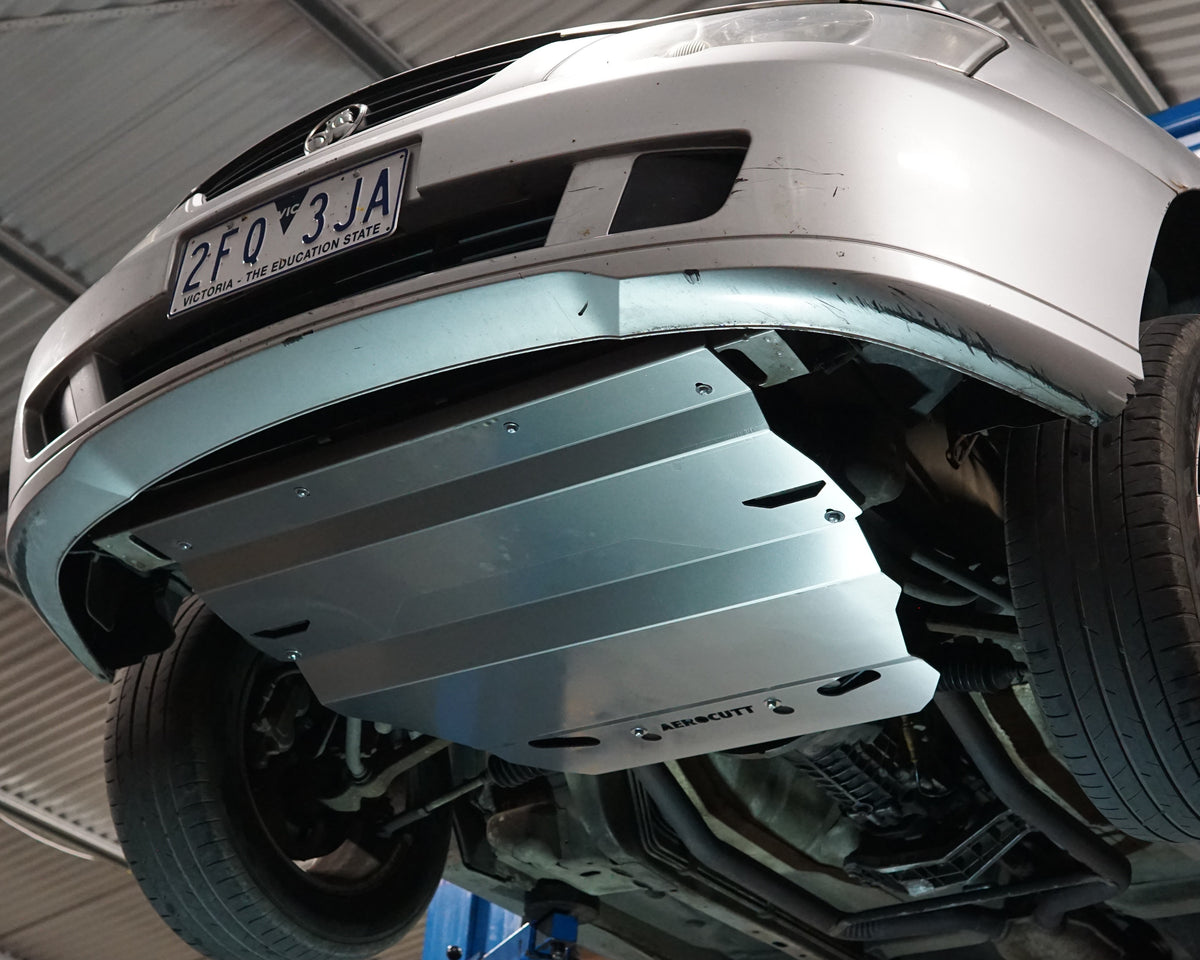 Holden Commodore VT front undercarriage with an Aerocutt aluminium heavy duty sump guard installed for protection