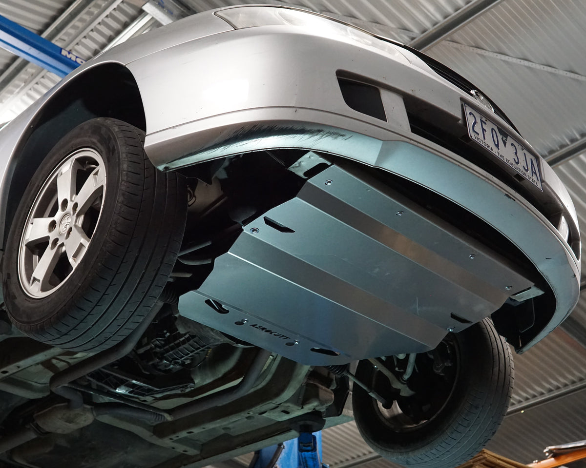 Holden Commodore VY front undercarriage with an Aerocutt aluminium heavy duty sump guard installed for protection
