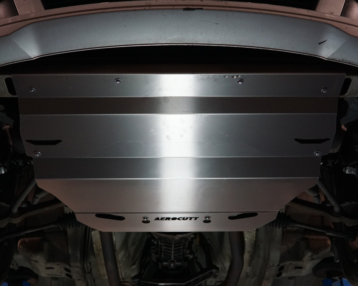 Holden Commodore VX front undercarriage with an Aerocutt aluminium heavy duty sump guard installed for protection