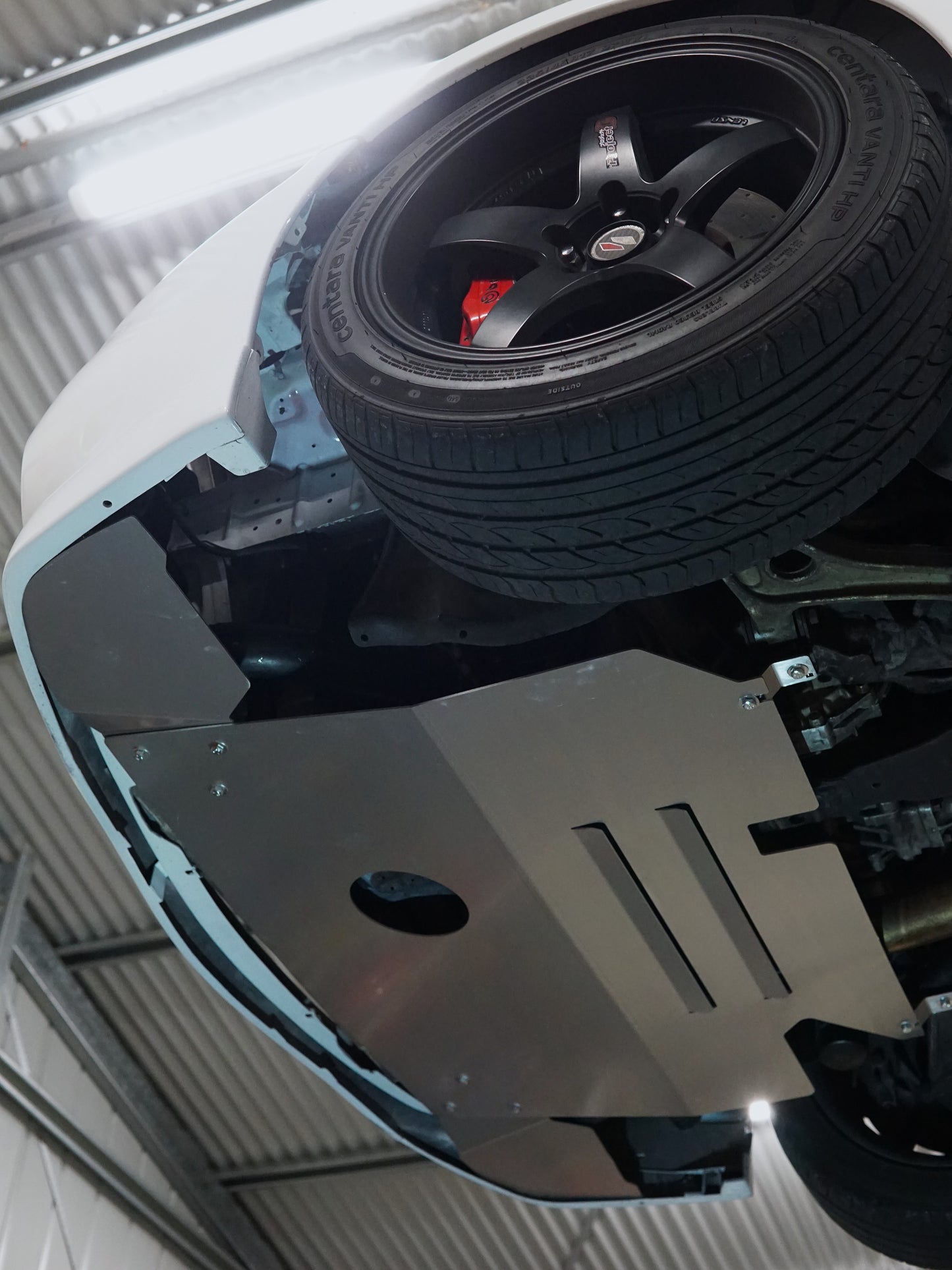 Close-up of a car's undercarriage with a wheel and suspension system on an evo 6 