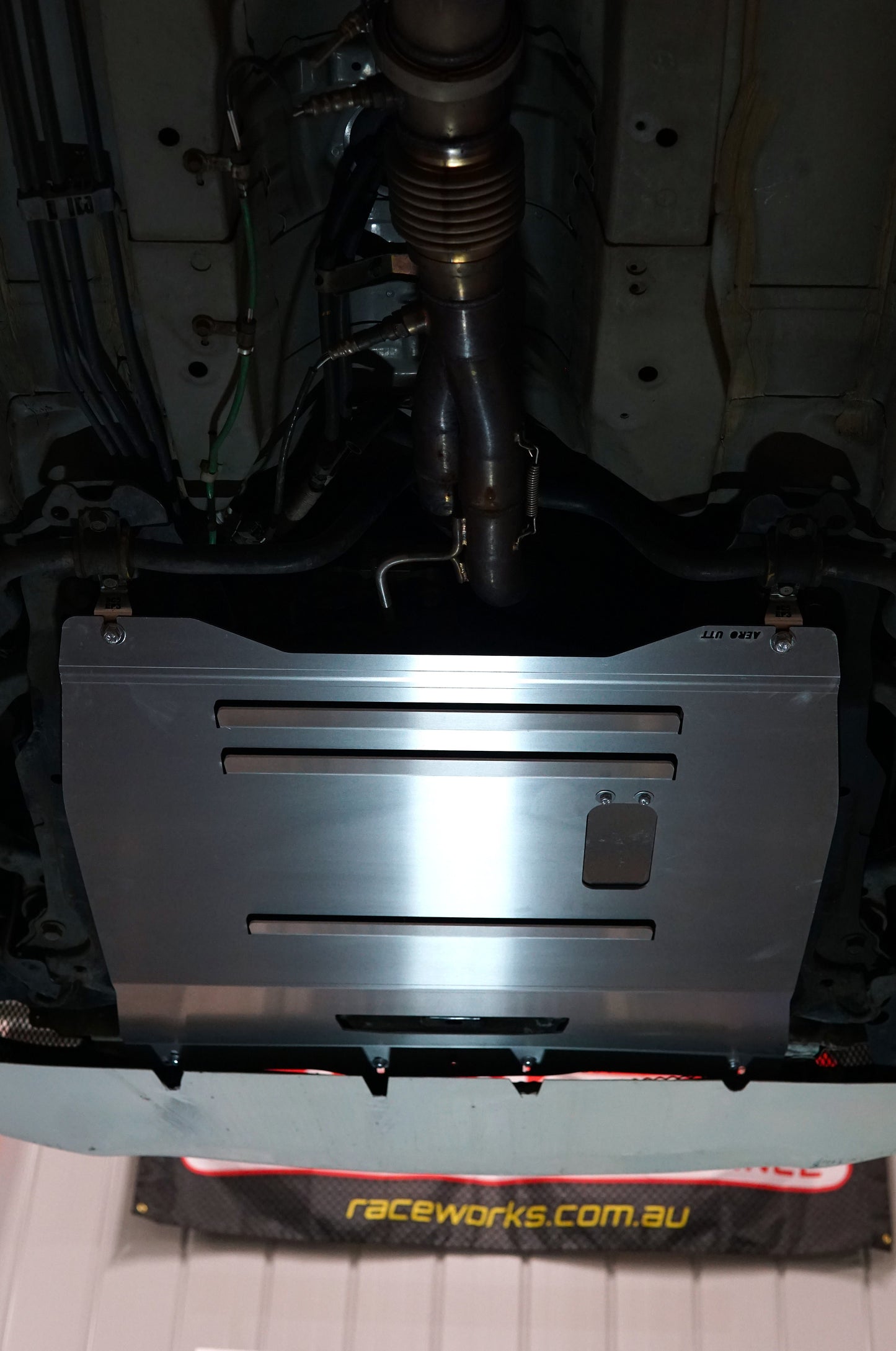 Metal undercarriage guard with visible branding on a vehicle dc5 ep3 civic honda