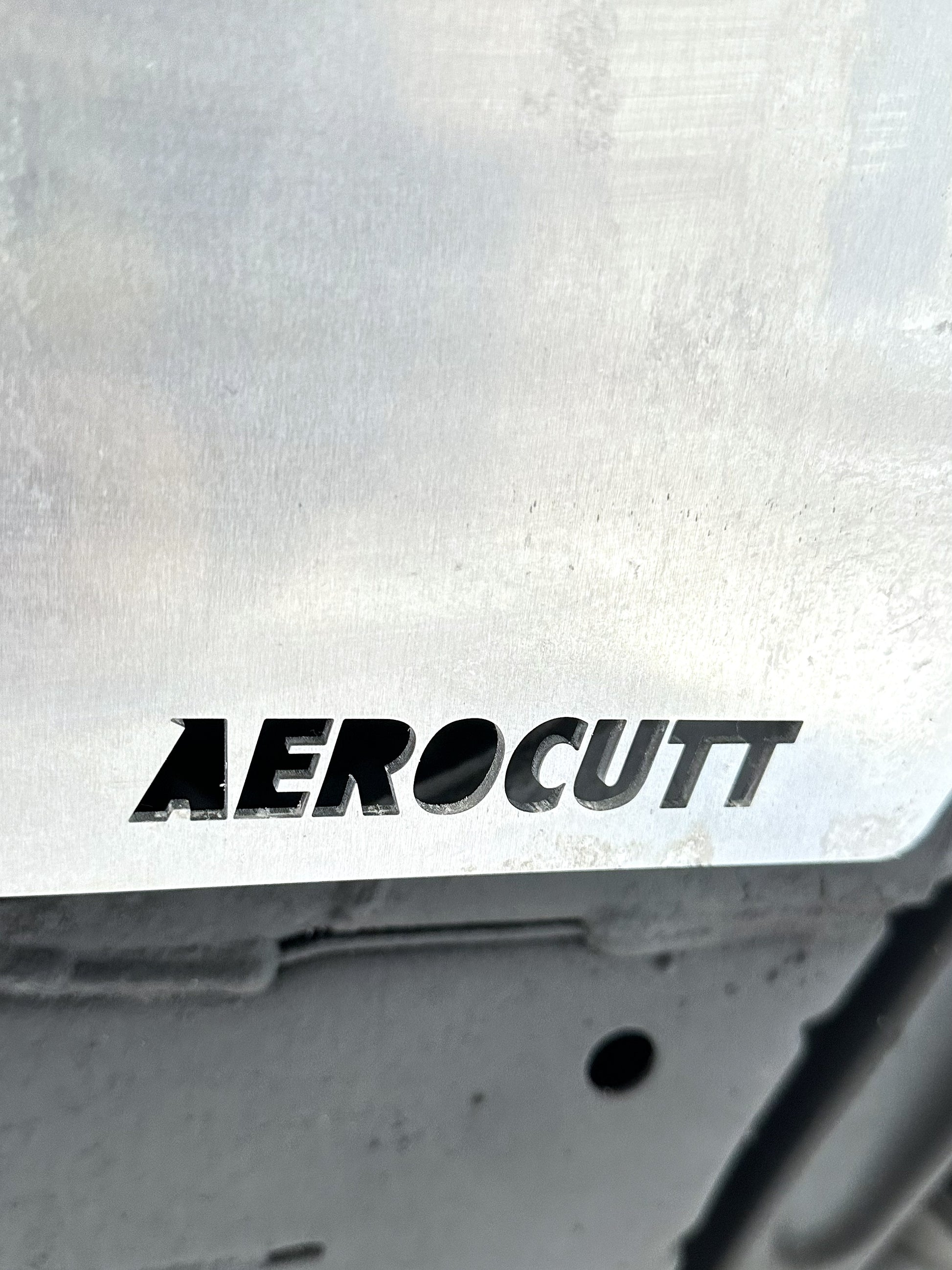 Aerocutt logo on a metallic surface of an evo 8 skid plate set 