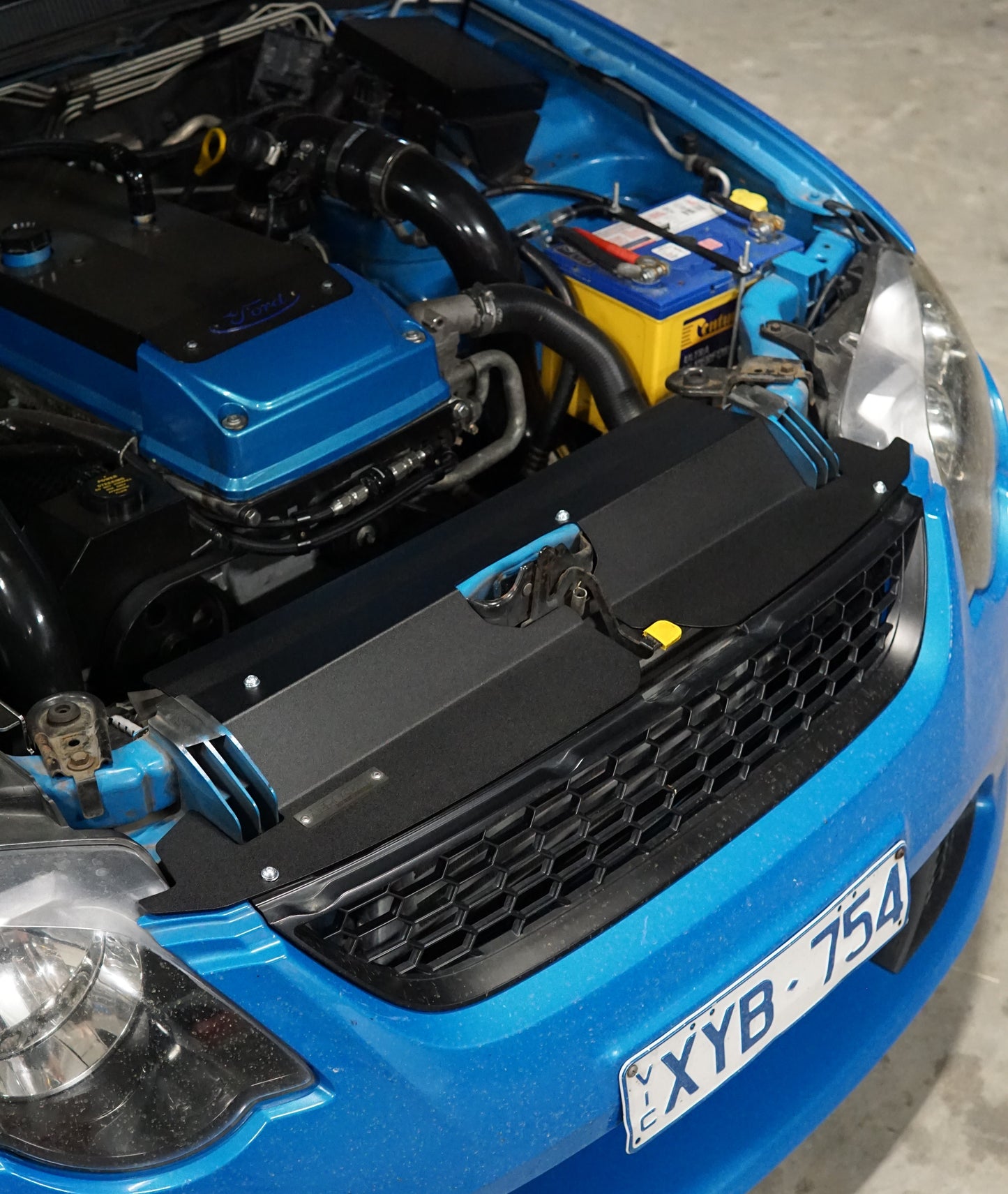 FG Ford falcon engine bay with bonnet open showing cooling panel fitted