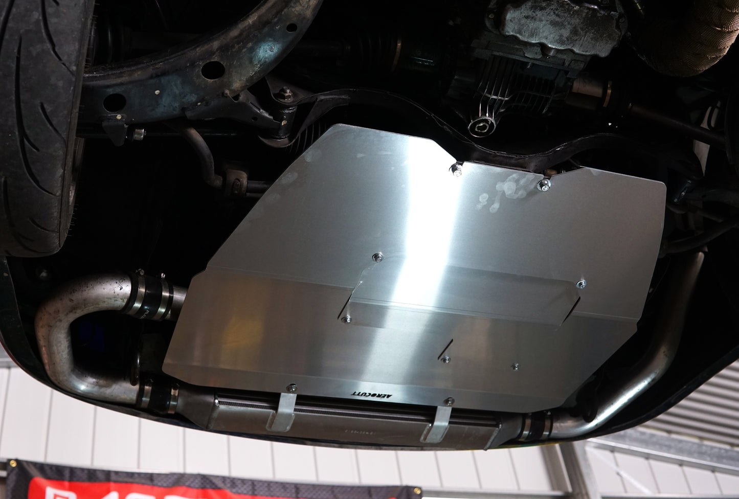 Metal skid plate on a vehicle's undercarriage with aerocutt