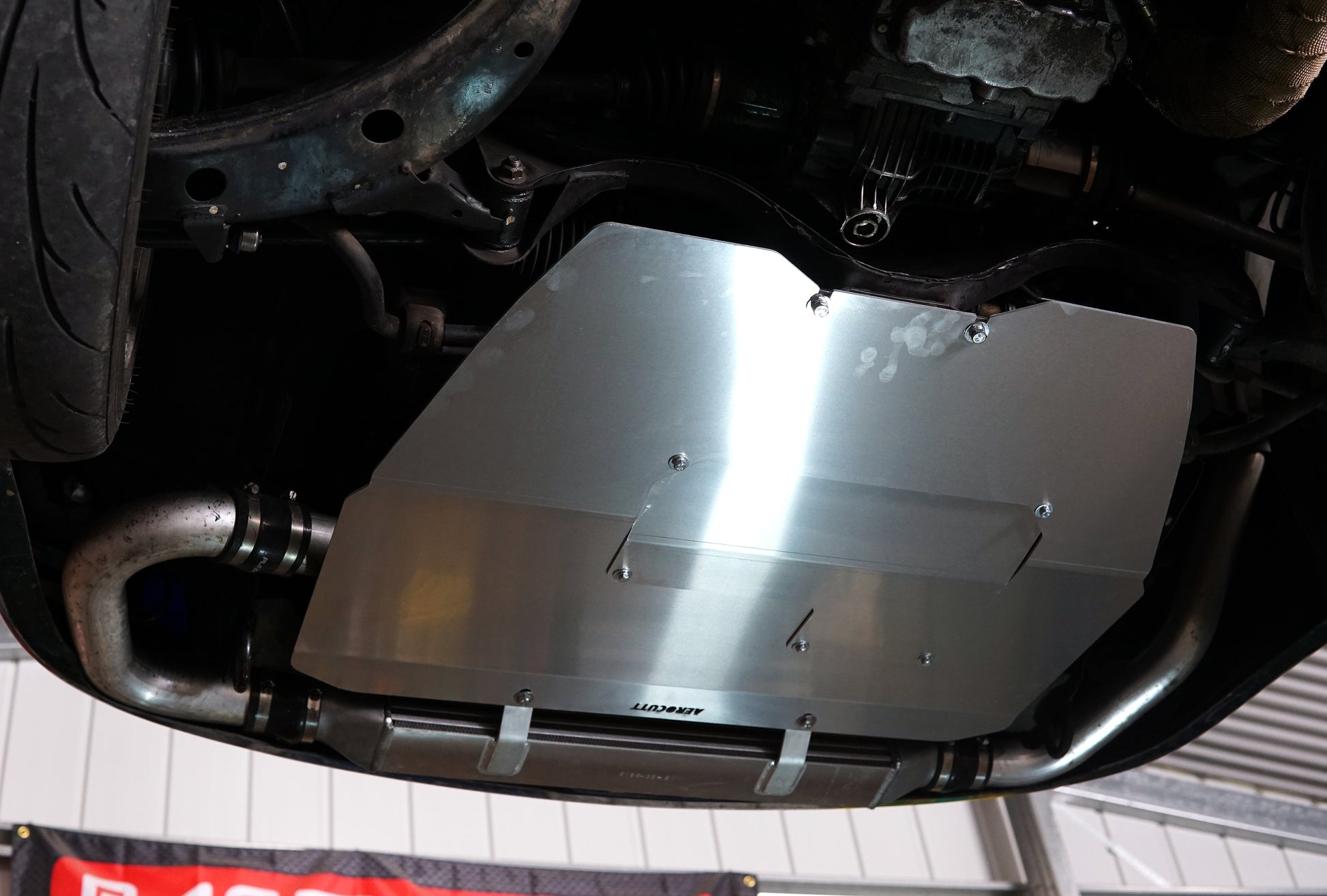 Metal skid plate on a vehicle's undercarriage with aerocutt