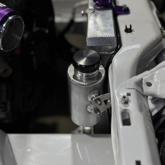 Nissan Silvia s13/180sx engine bay with Lazaro Motorsports overflow bottle mounted in raw aluminium