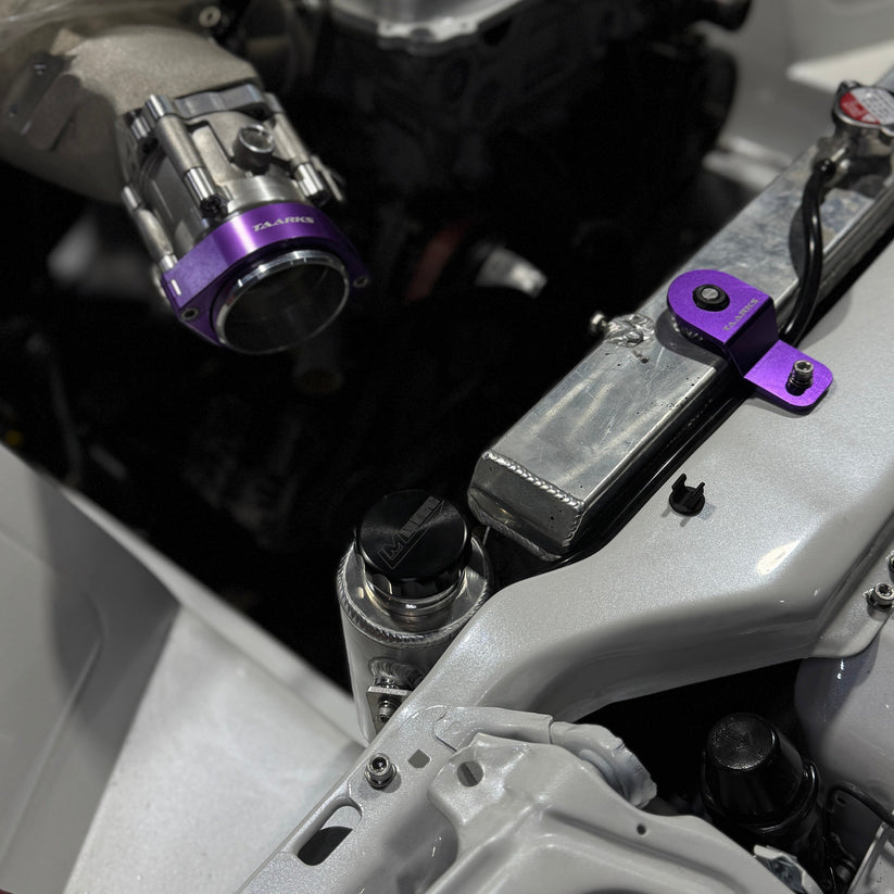 Nissan Silvia s13/180sx engine bay with Lazaro Motorsports overflow bottle mounted in raw aluminium
