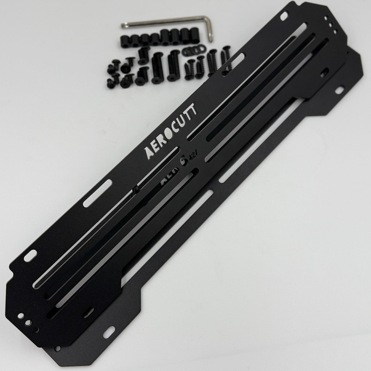 A black Aerocutt victorian heritage plate aluminum mounting plate with a silver Allen wrench and black hardware pieces, displayed on a clean white background.