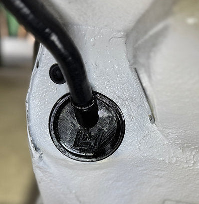 black loom grommet in the wheel well of a nissan