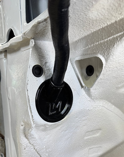 black loom grommet in the wheel well of a nissan