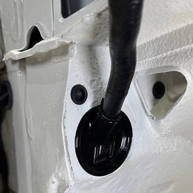 black loom grommet in the wheel well of a nissan