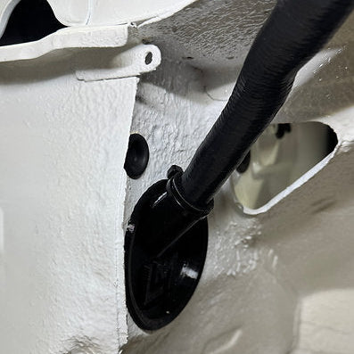 black loom grommet in the wheel well of a nissan